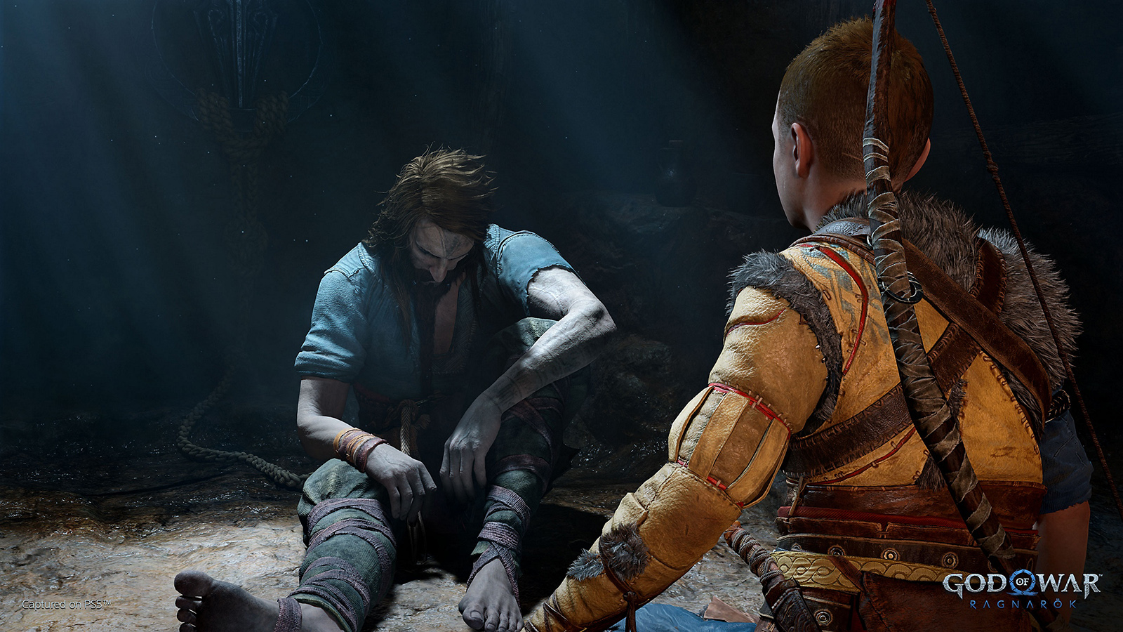 Kratos and Atreus in a cave in God of War: Ragnarök 